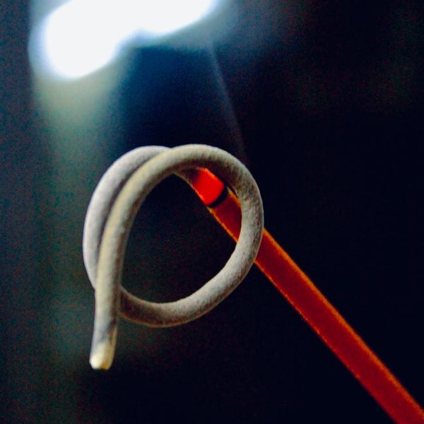 Incense stick smoke in a dark room